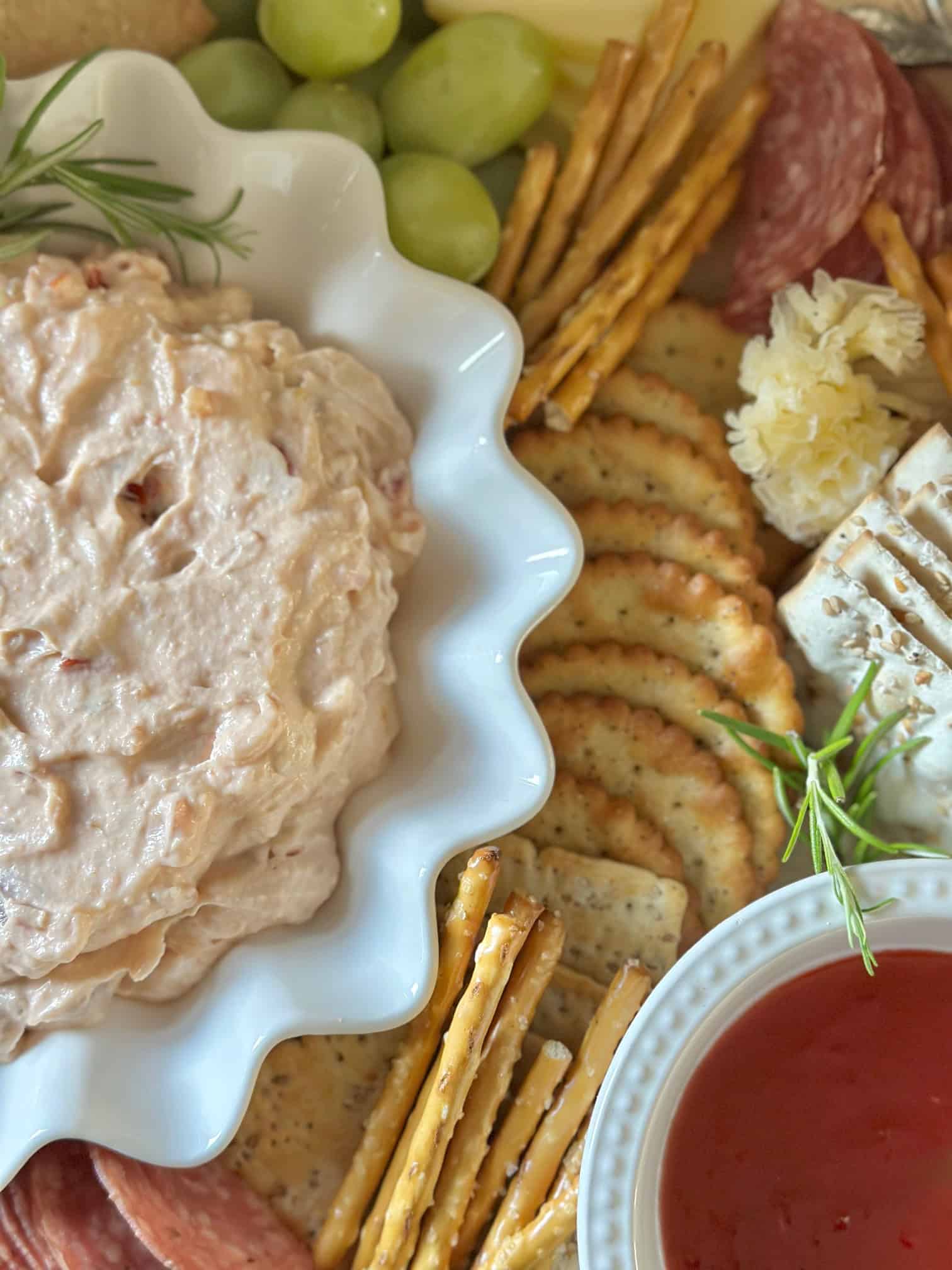 Mixed or whipped dip in a white scallop bowl on a board.