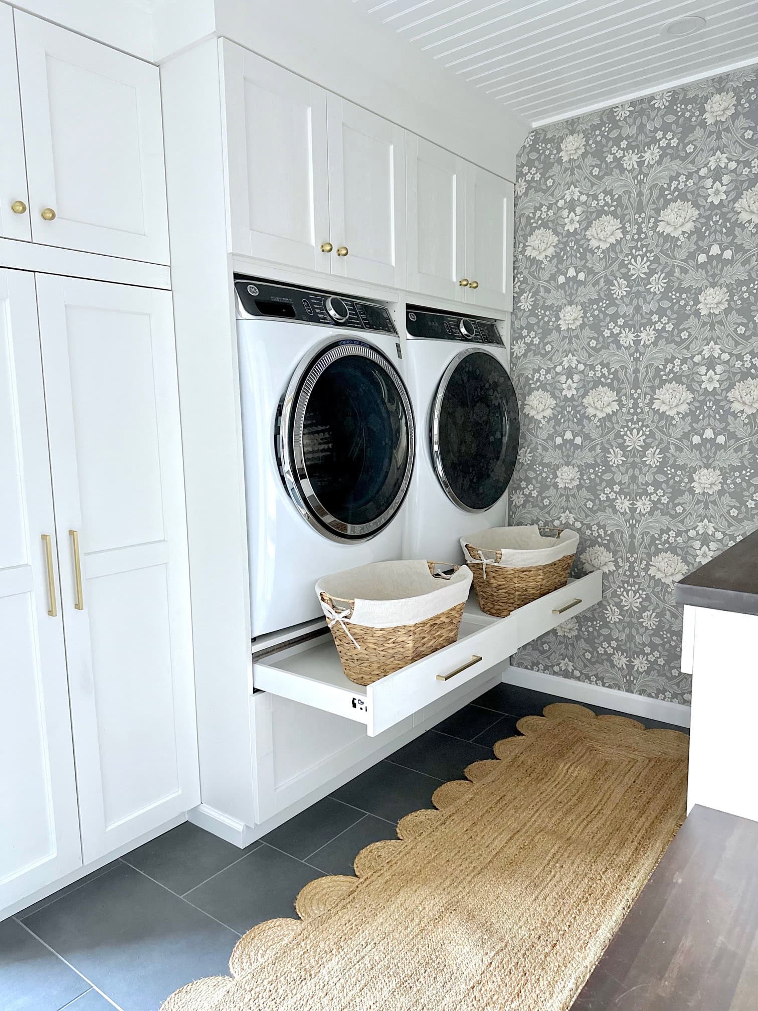 Two slim drawers work as trays to hold laundry baskets right below our raised washer and dryer.