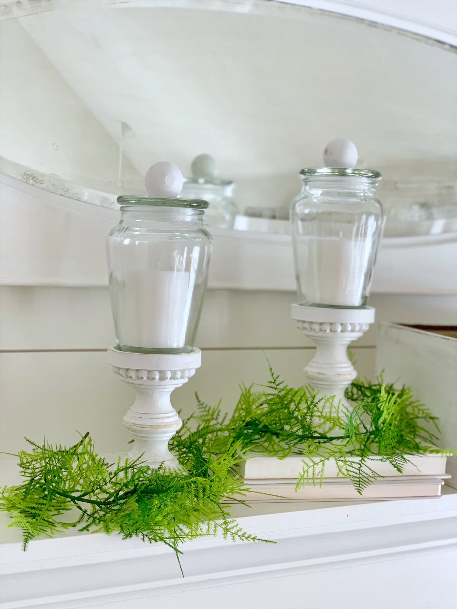 Jars with cover on top of thrifted candle stick for a beautiful candle display idea. 