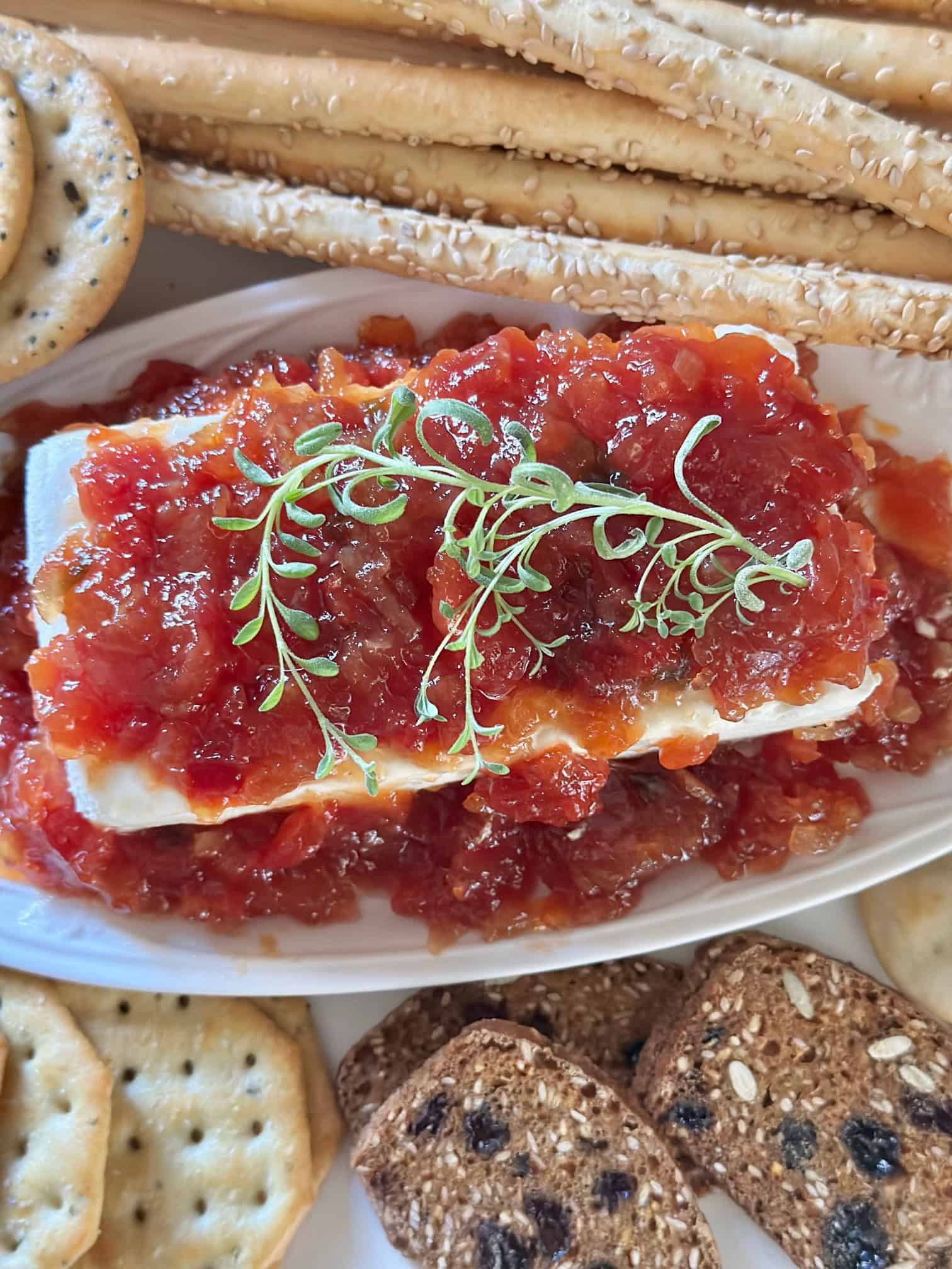 Red pepper jelly poured over a block of cream cheese. 