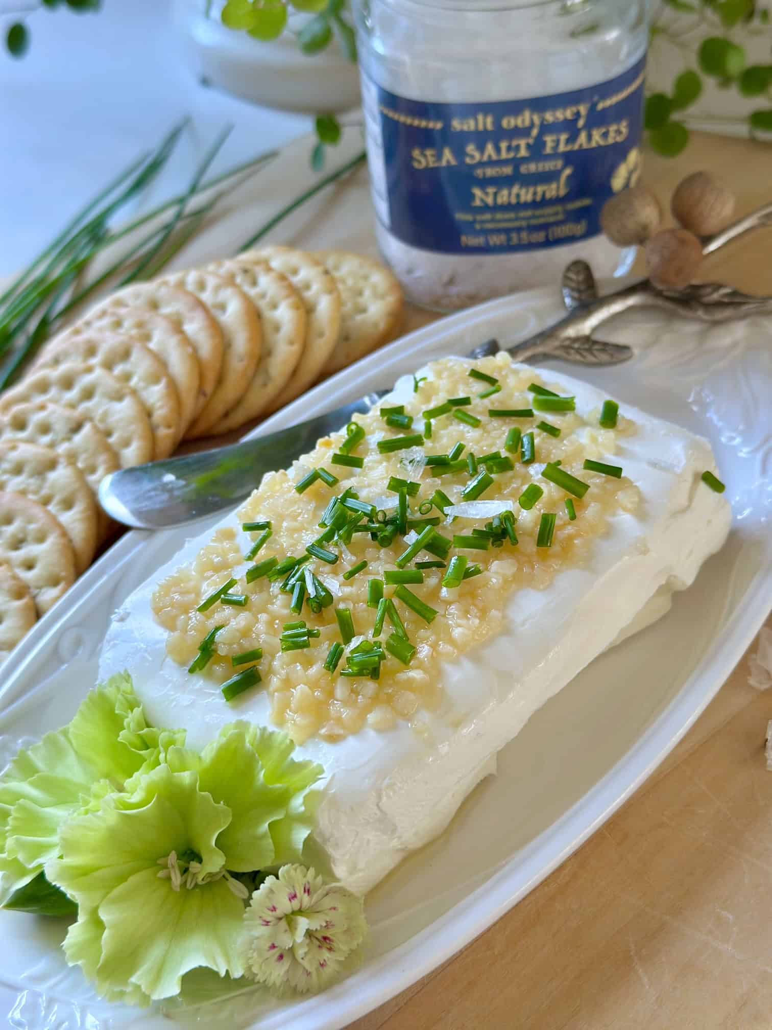 Cream cheese block with garlic, chives and salt flakes. 
