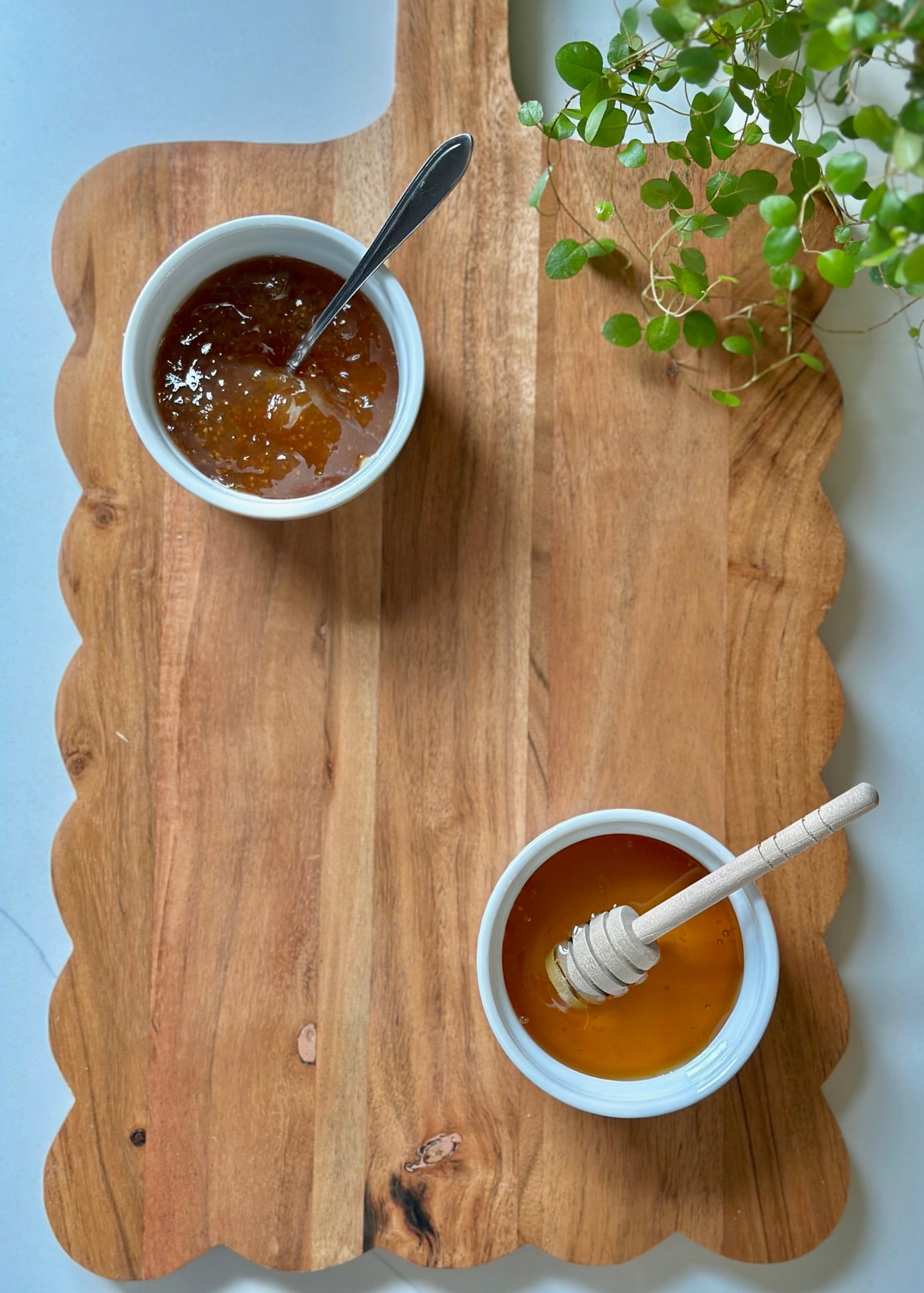 Two bowls on a charcuterie board.
