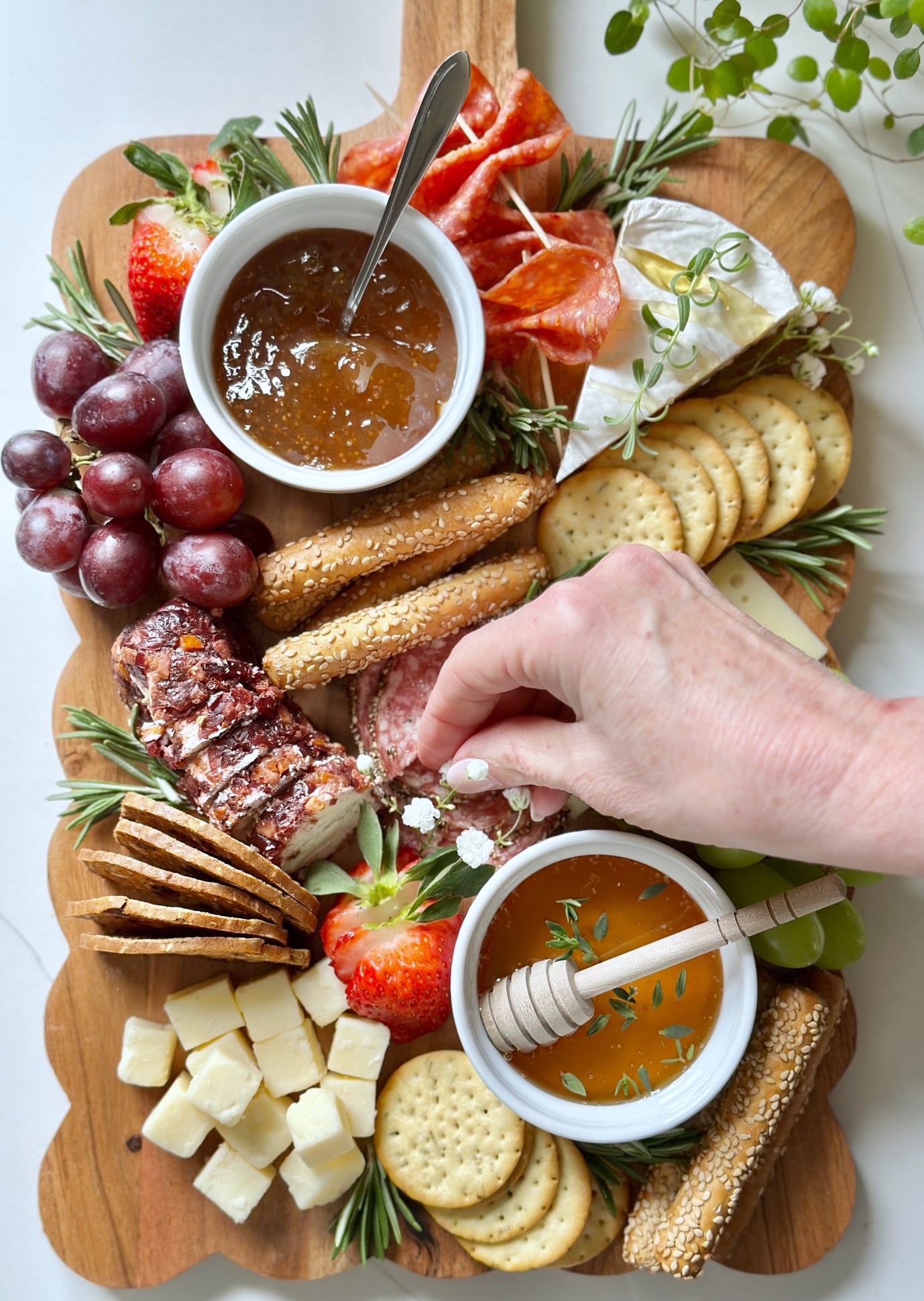 A full styled charcuterie board with two bowls filled.