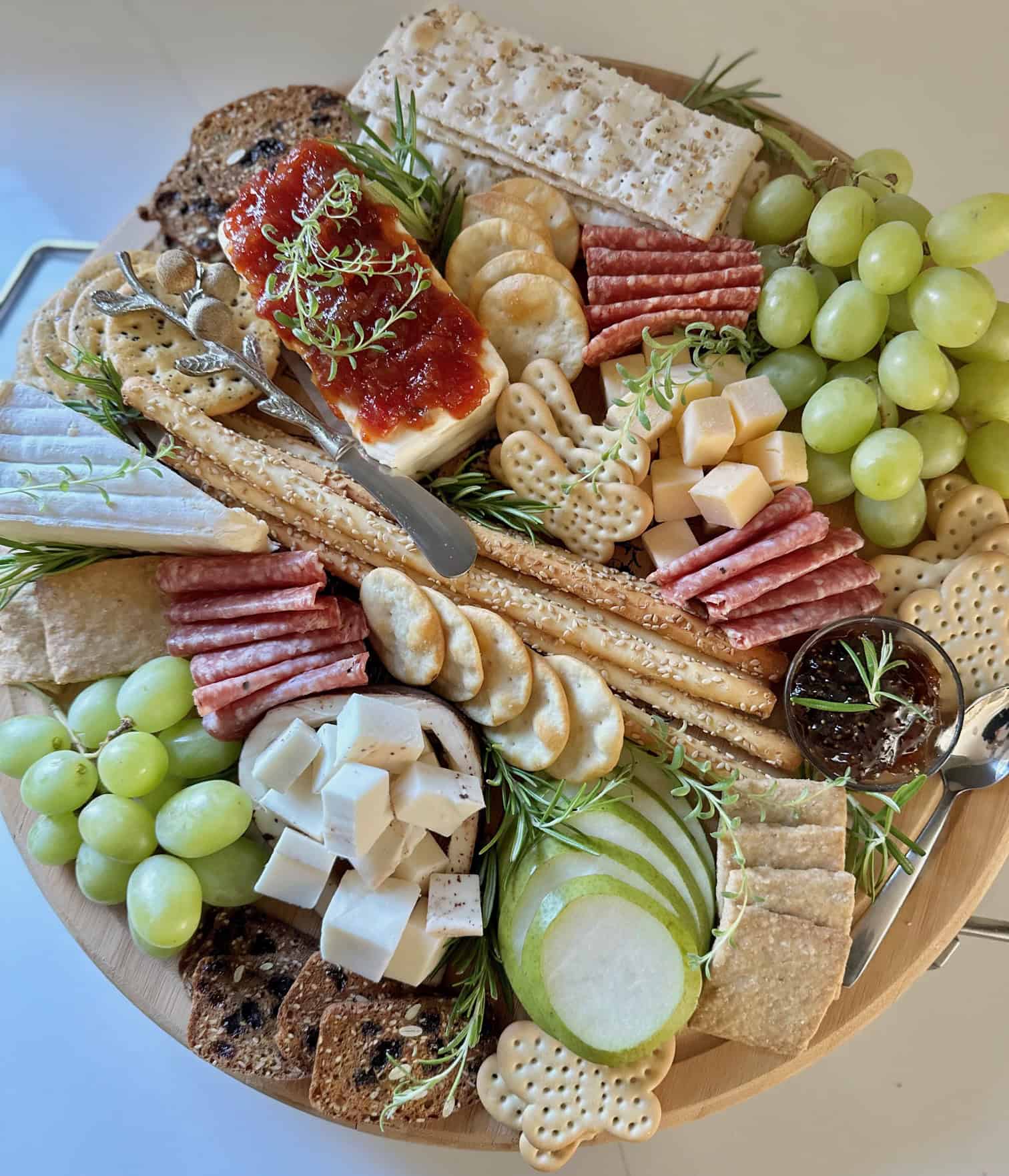 A beautiful charcuterie board with cream cheese pepper jelly. 