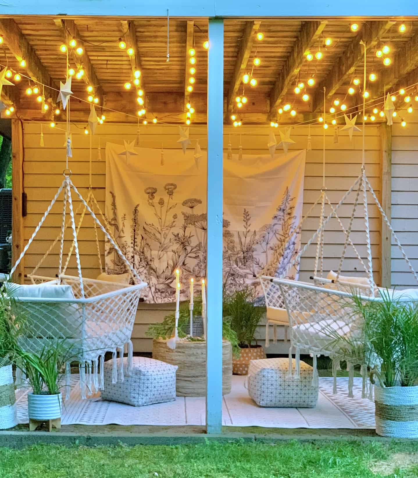 Bright under deck space featuring cafe lights and hanging hammock chairs. 