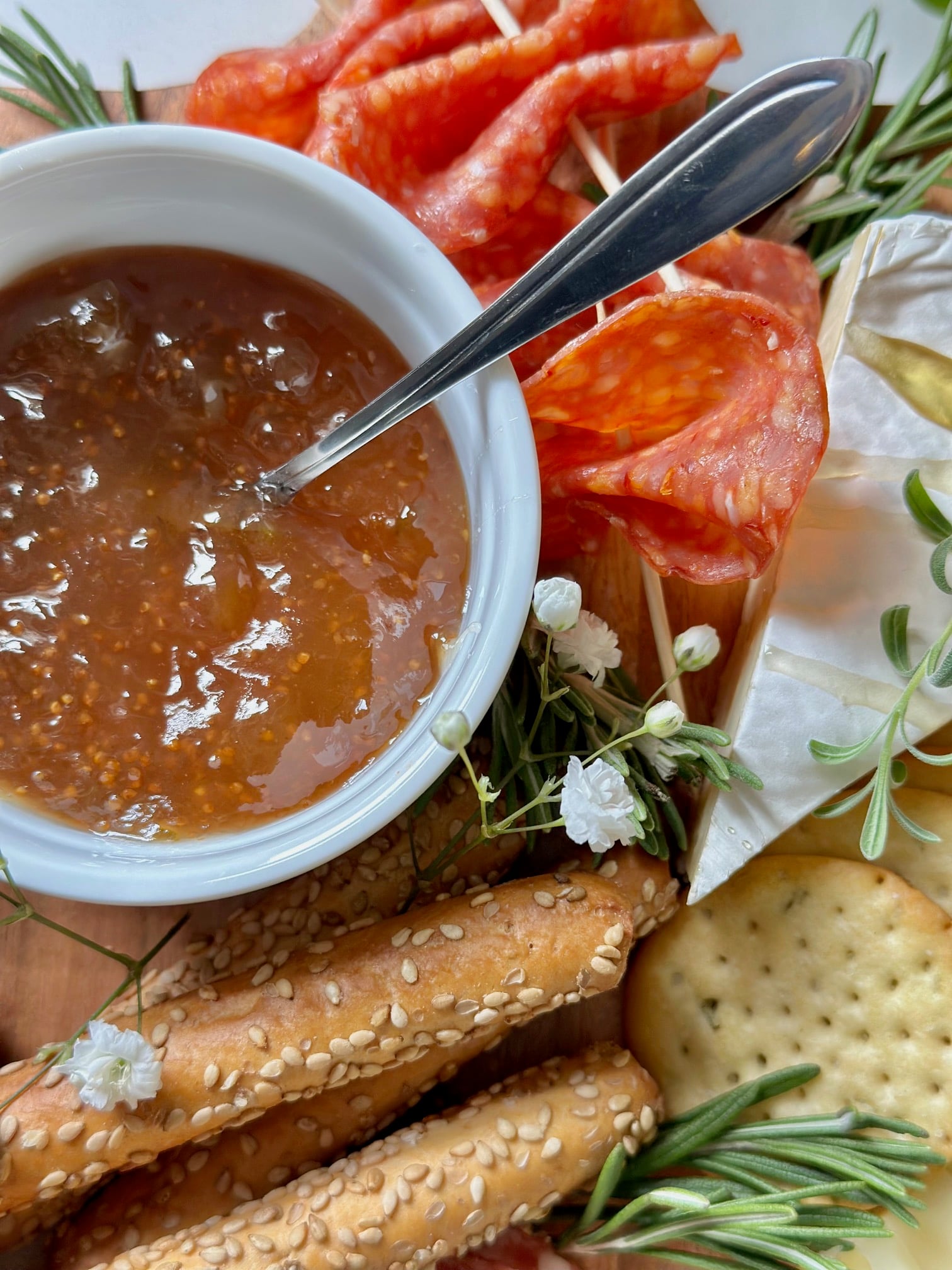 Fig jam in a bowl with a spoon. 