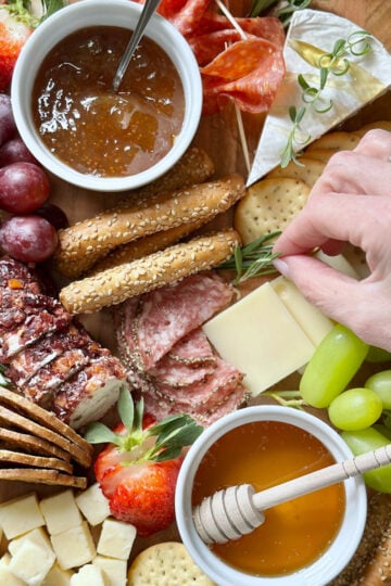 Fresh herbs as garnish on a charcuterie board.