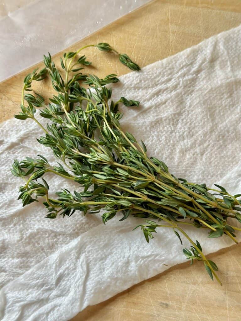 Thyme stems on a damp paper towel. 