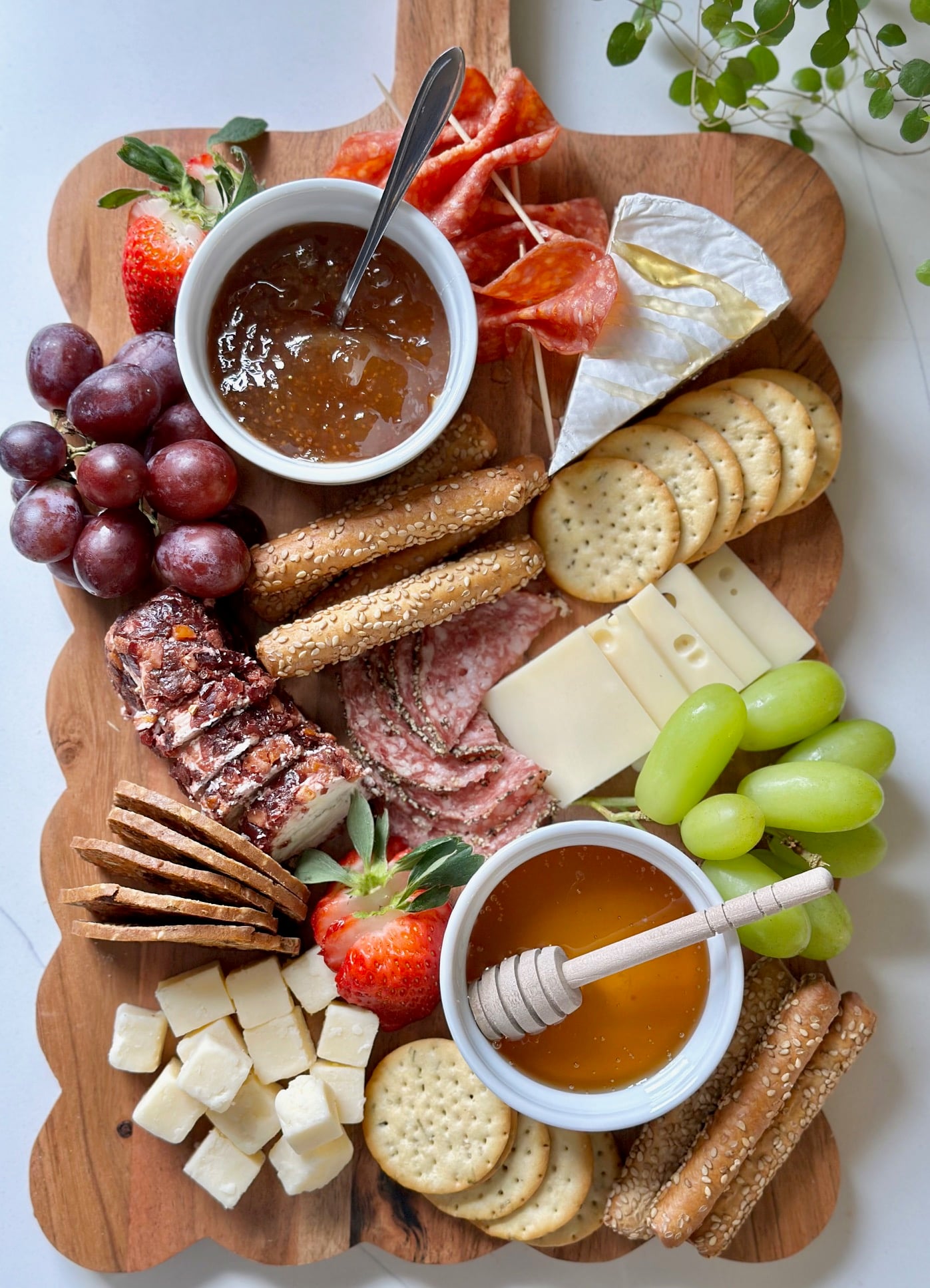 Grapes and strawberries added to the charcuterie board.