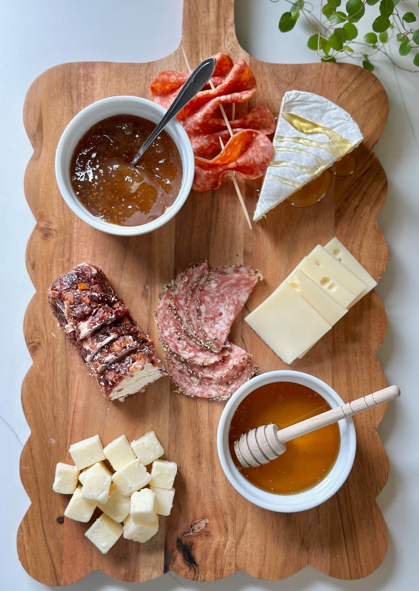 Meats added to the charcuterie board.