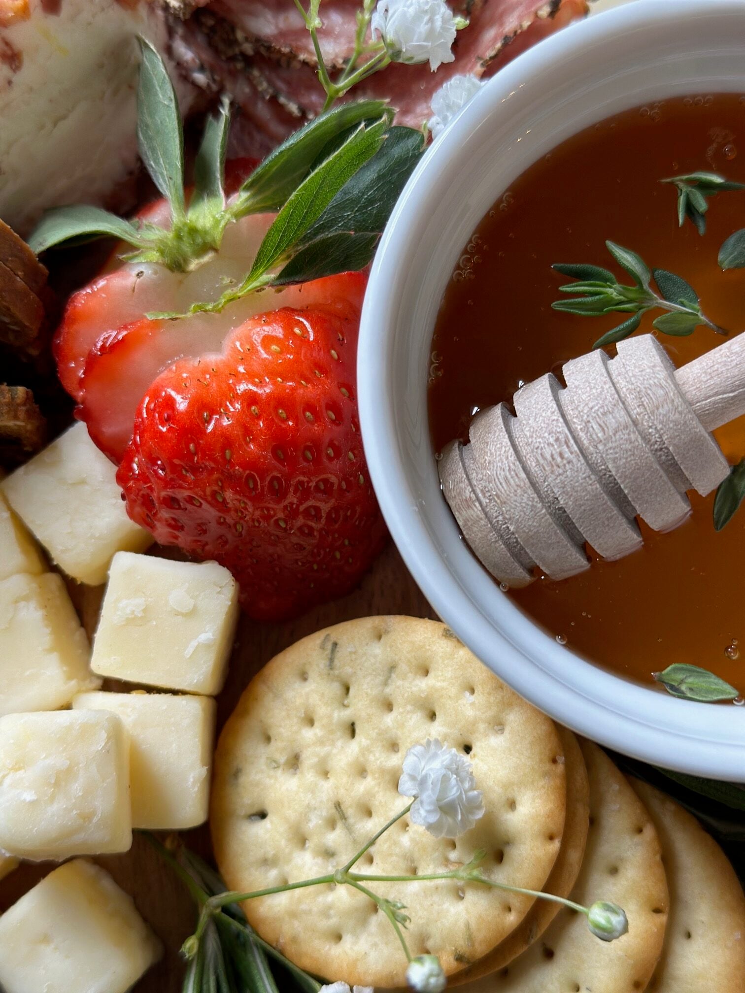 Bowl of honey on a board. 