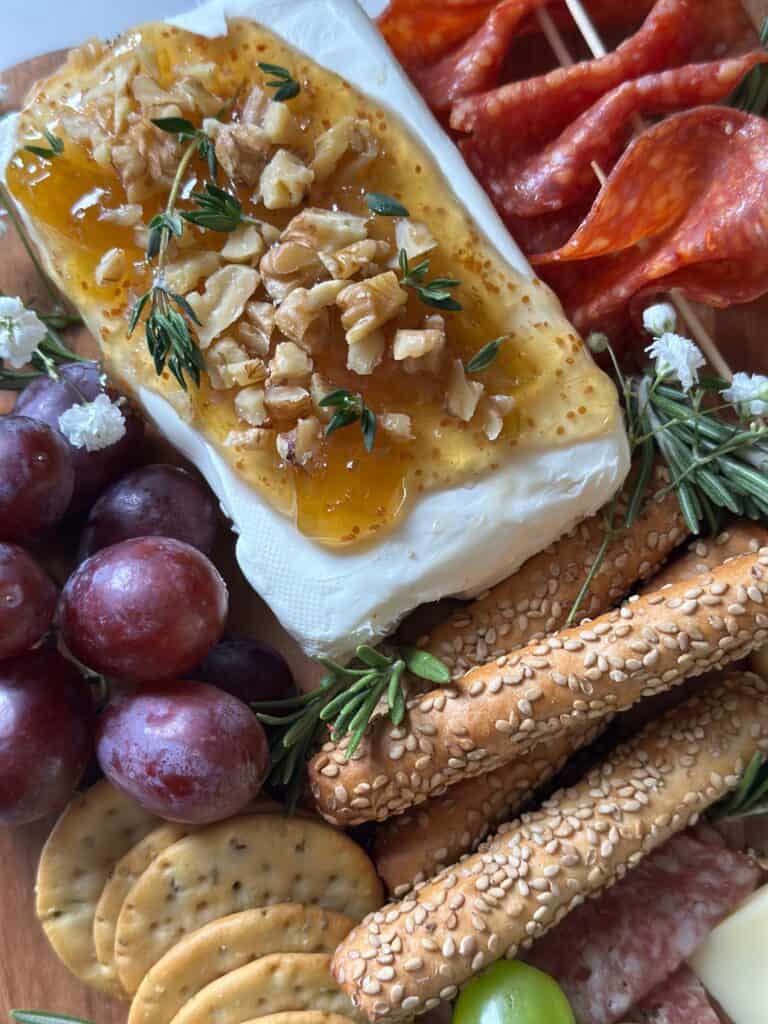 Thyme leaves on cream cheese with fig jam on it. 