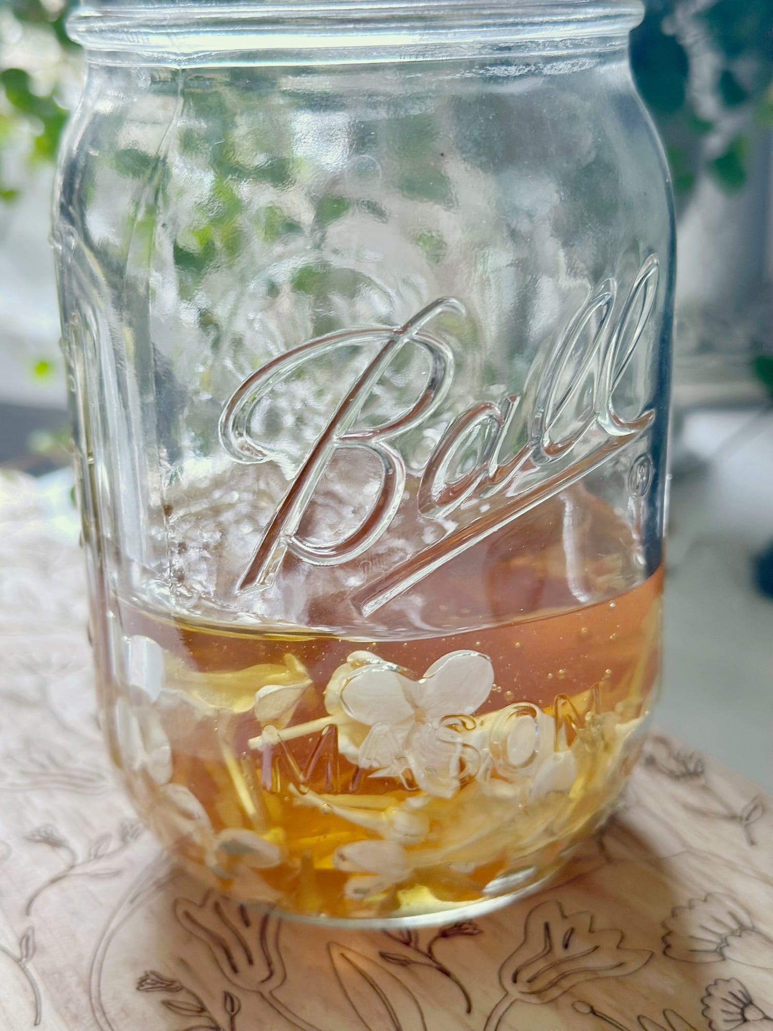 Lilacs in honey in a jar.