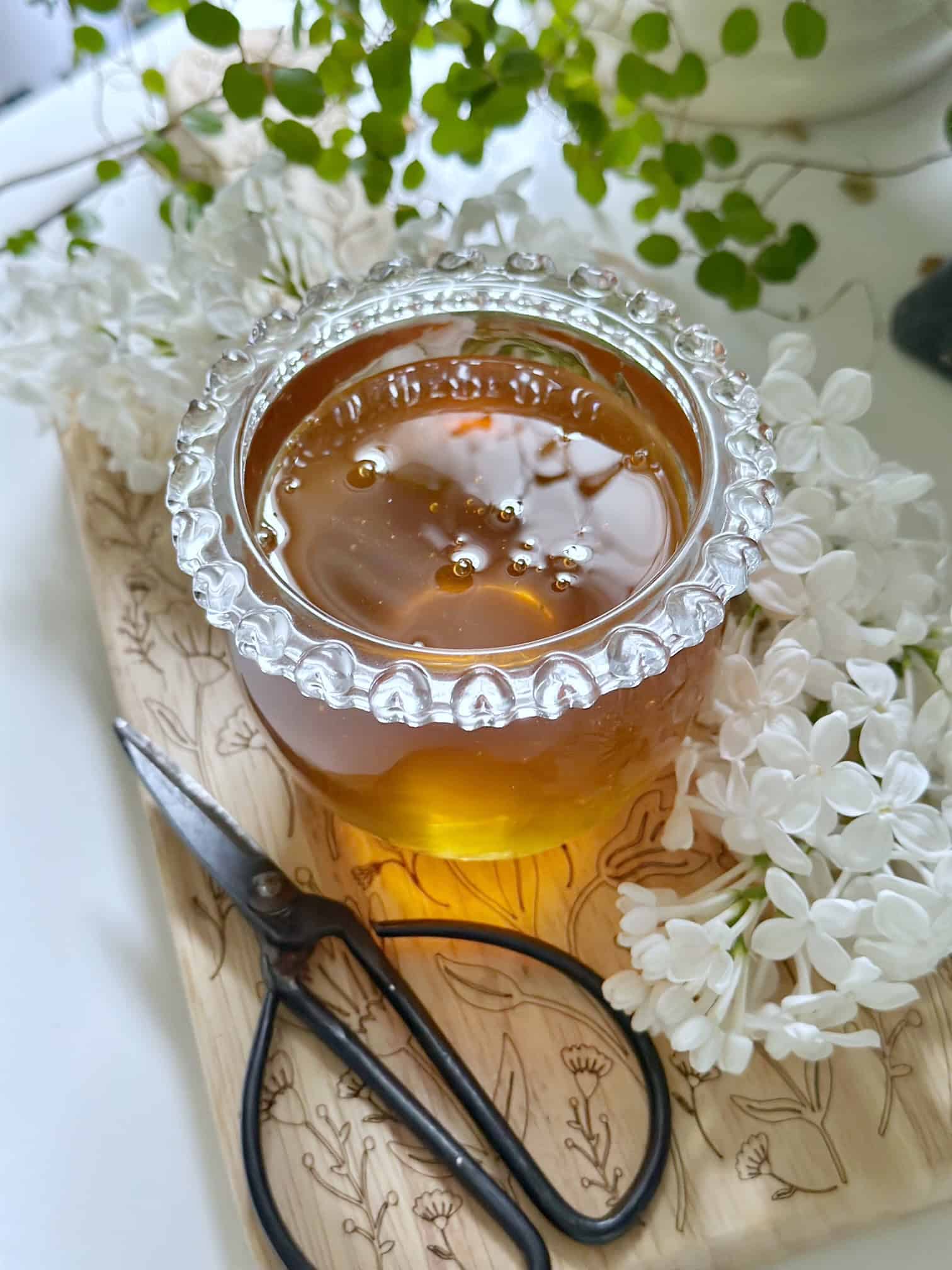 Honey with white lilac flowers. 