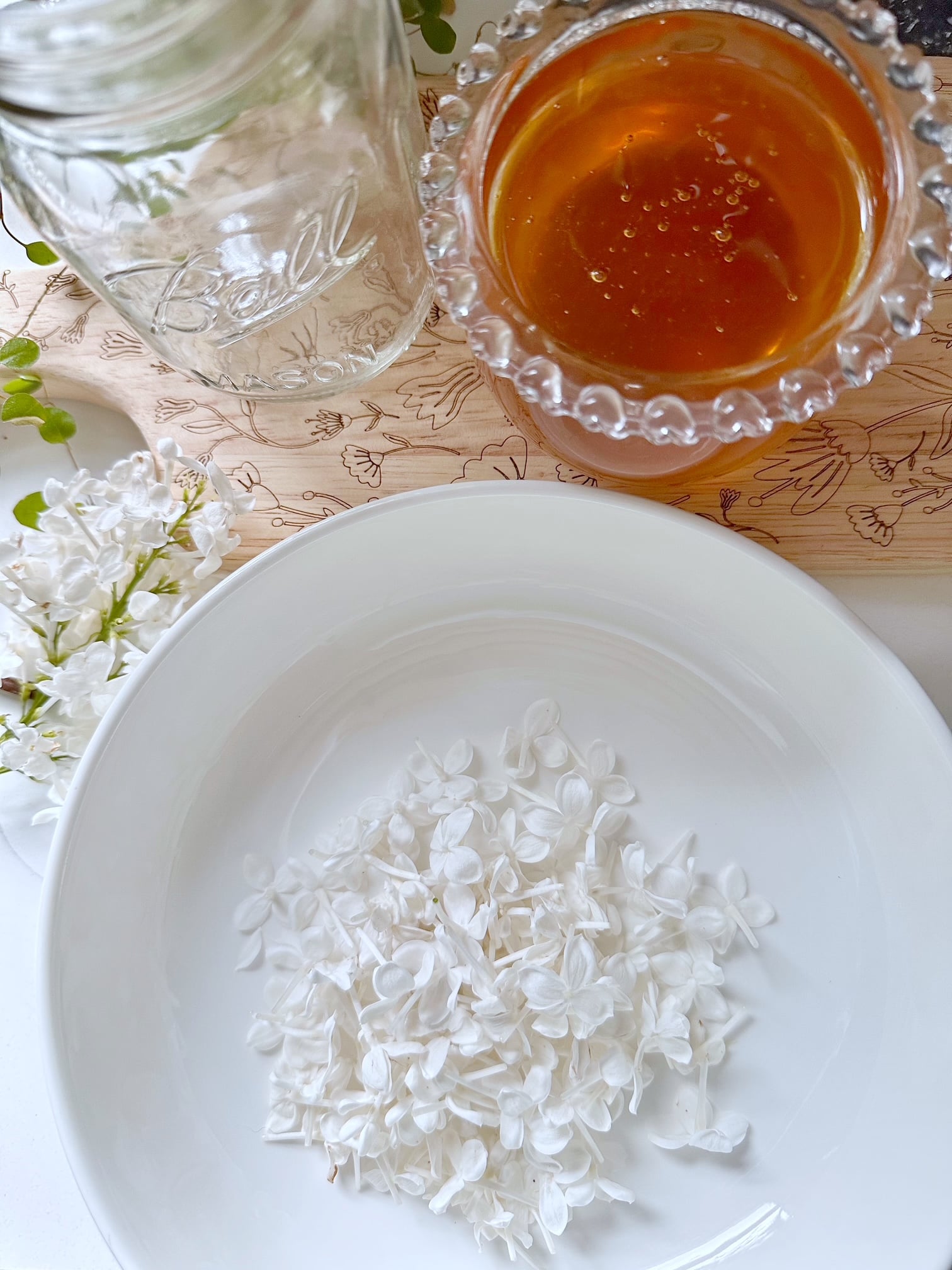 White lilacs in a bowl. Honey in a bowl. 