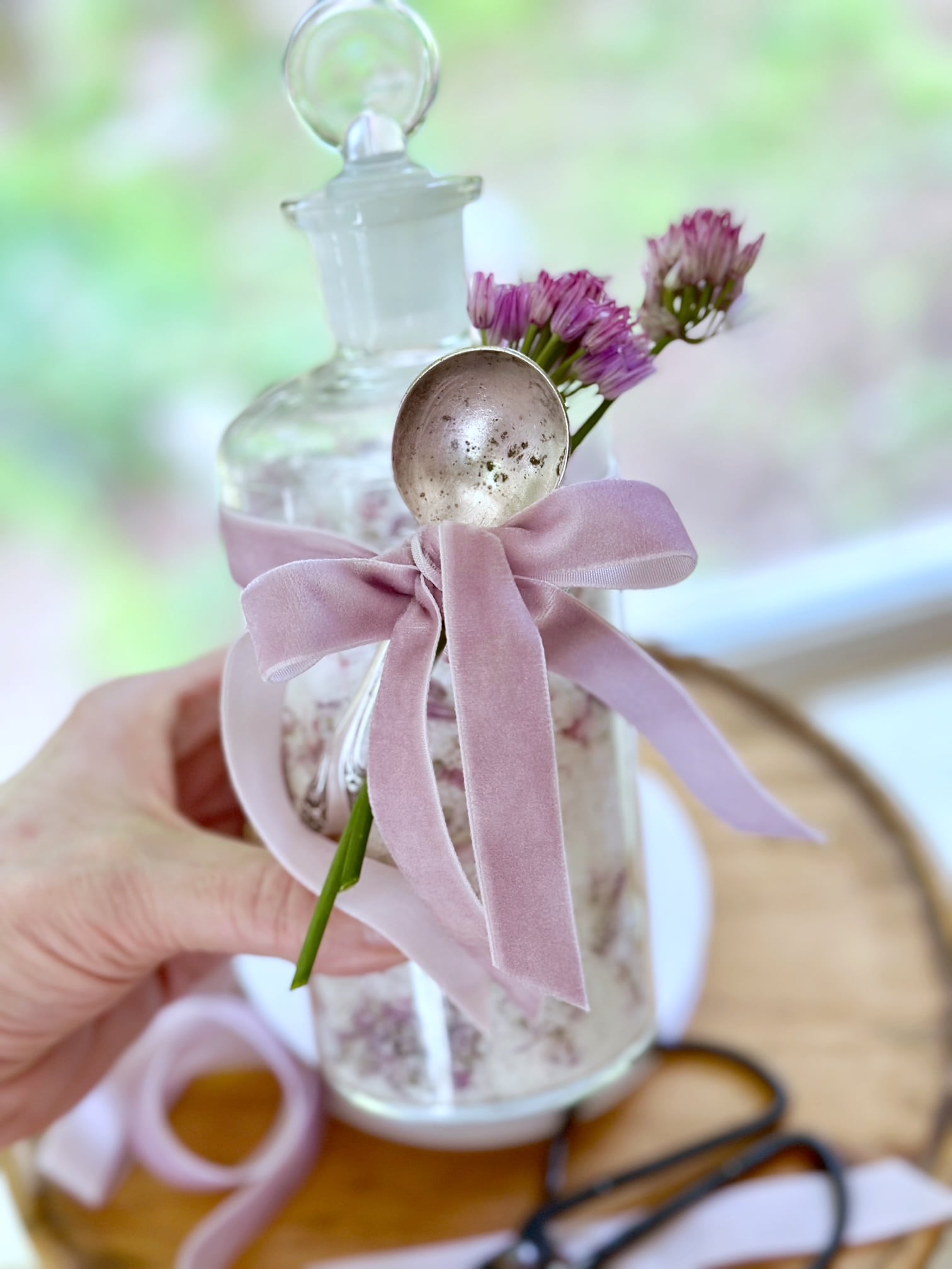 Gift of chive flower salt in a glass jar with a vintage spoon.