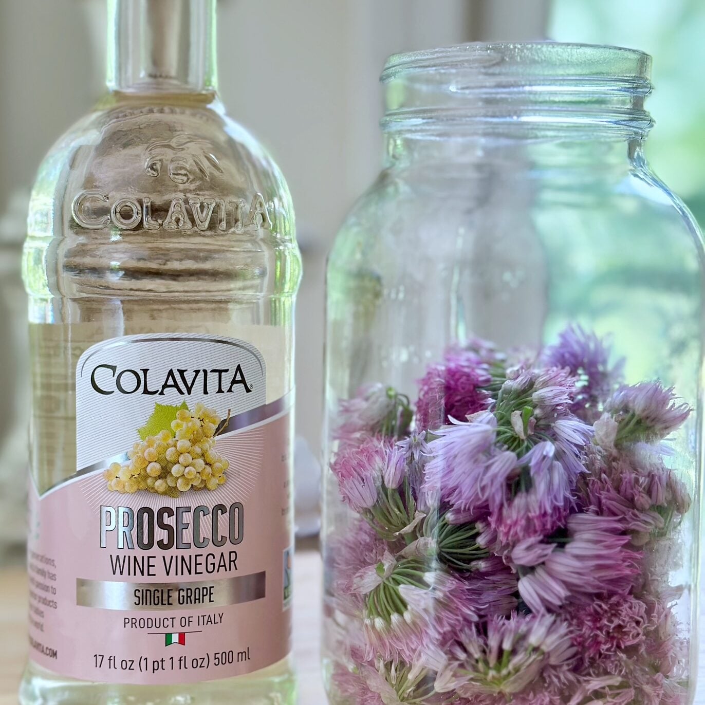 Vinegar with a jar of chive flowers.