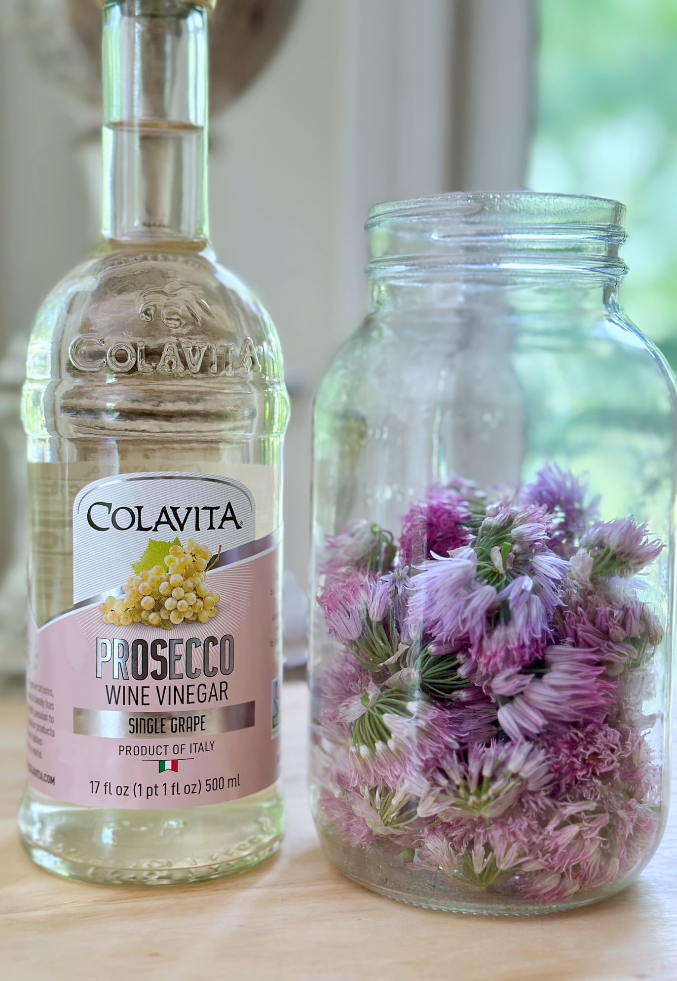 Vinegar with a jar of chive flowers. 