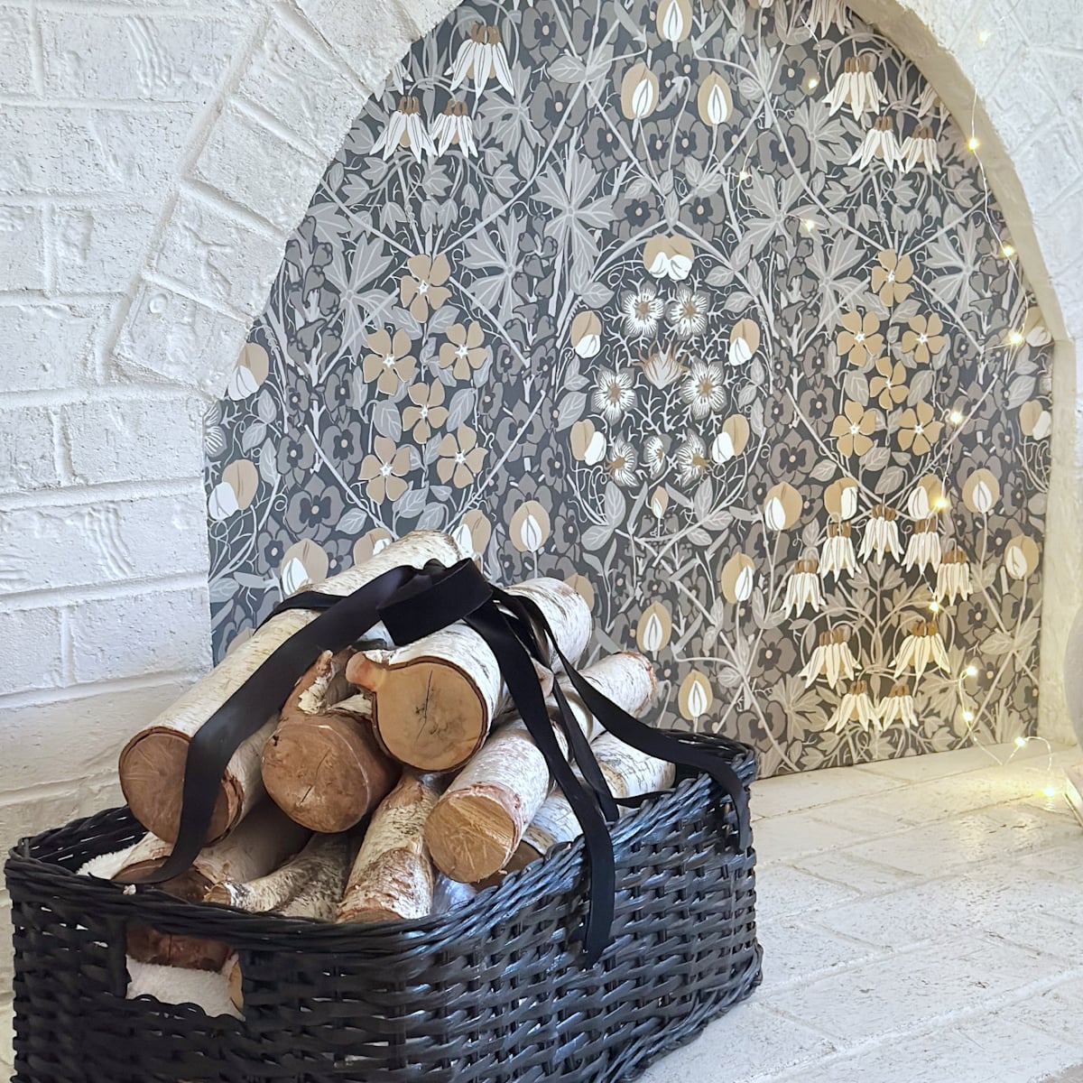 A wallpaper covered fireplace opening.