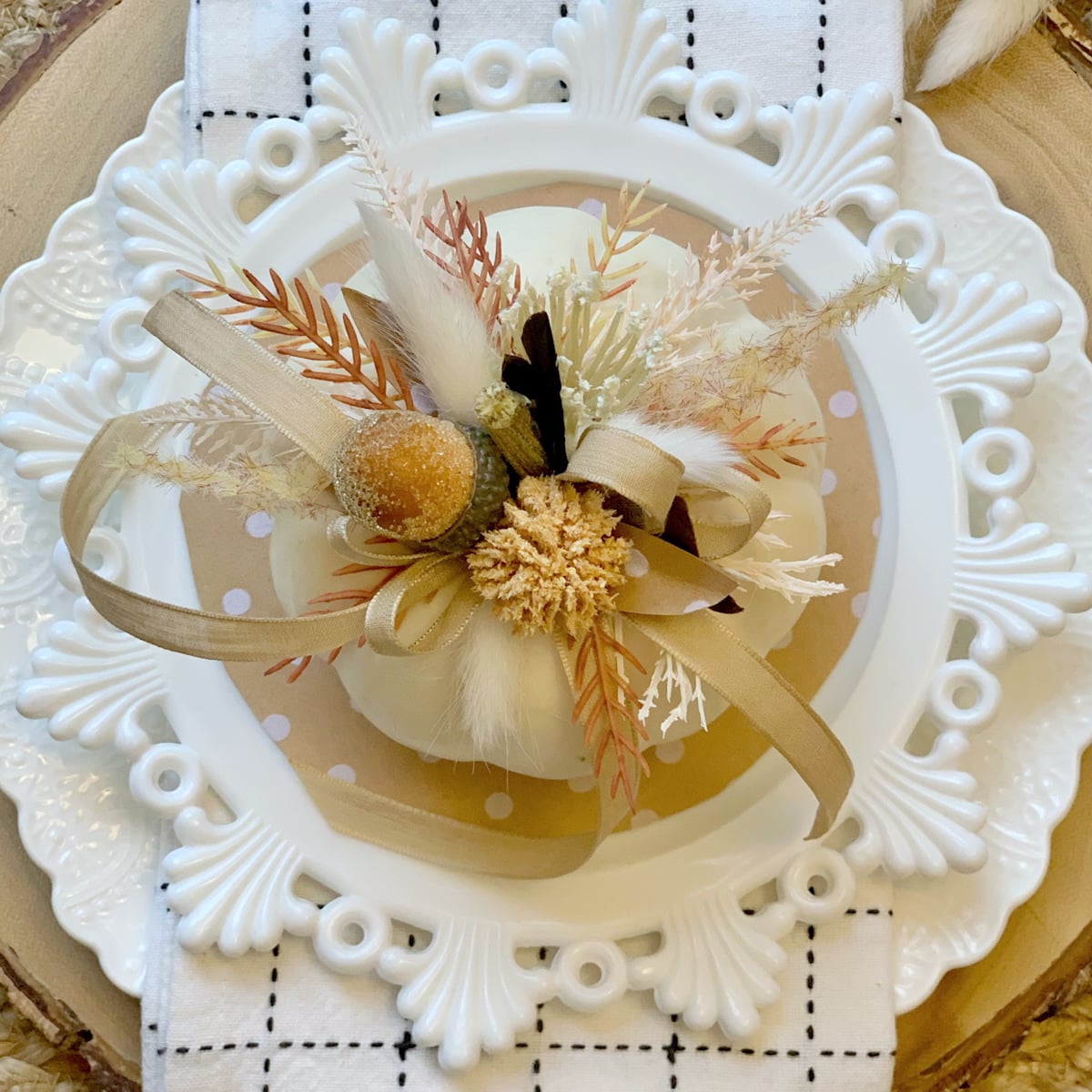Decorated white pumpkin on a place setting. 