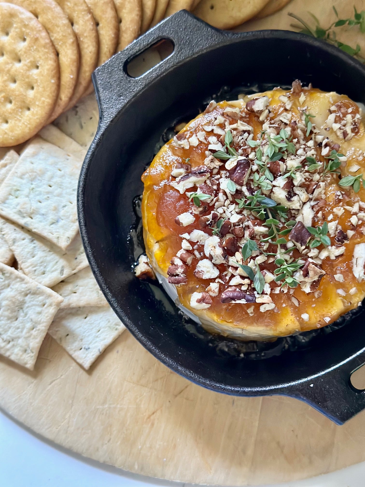 baked brie with preserves in a cast iron pan. 