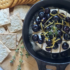 Blueberry baked brie featuring fresh blueberries.