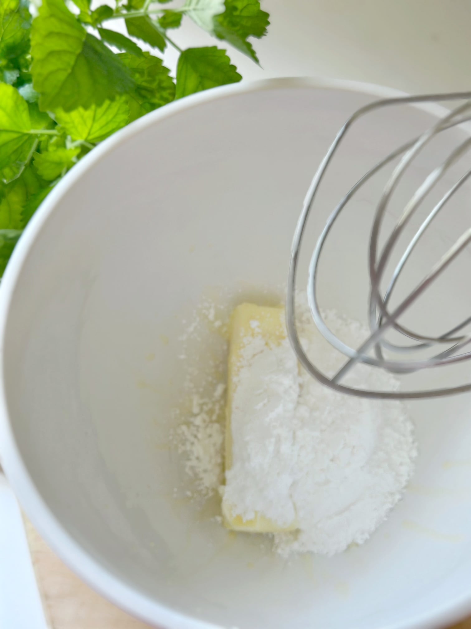 Mixing butter and powdered sugar.