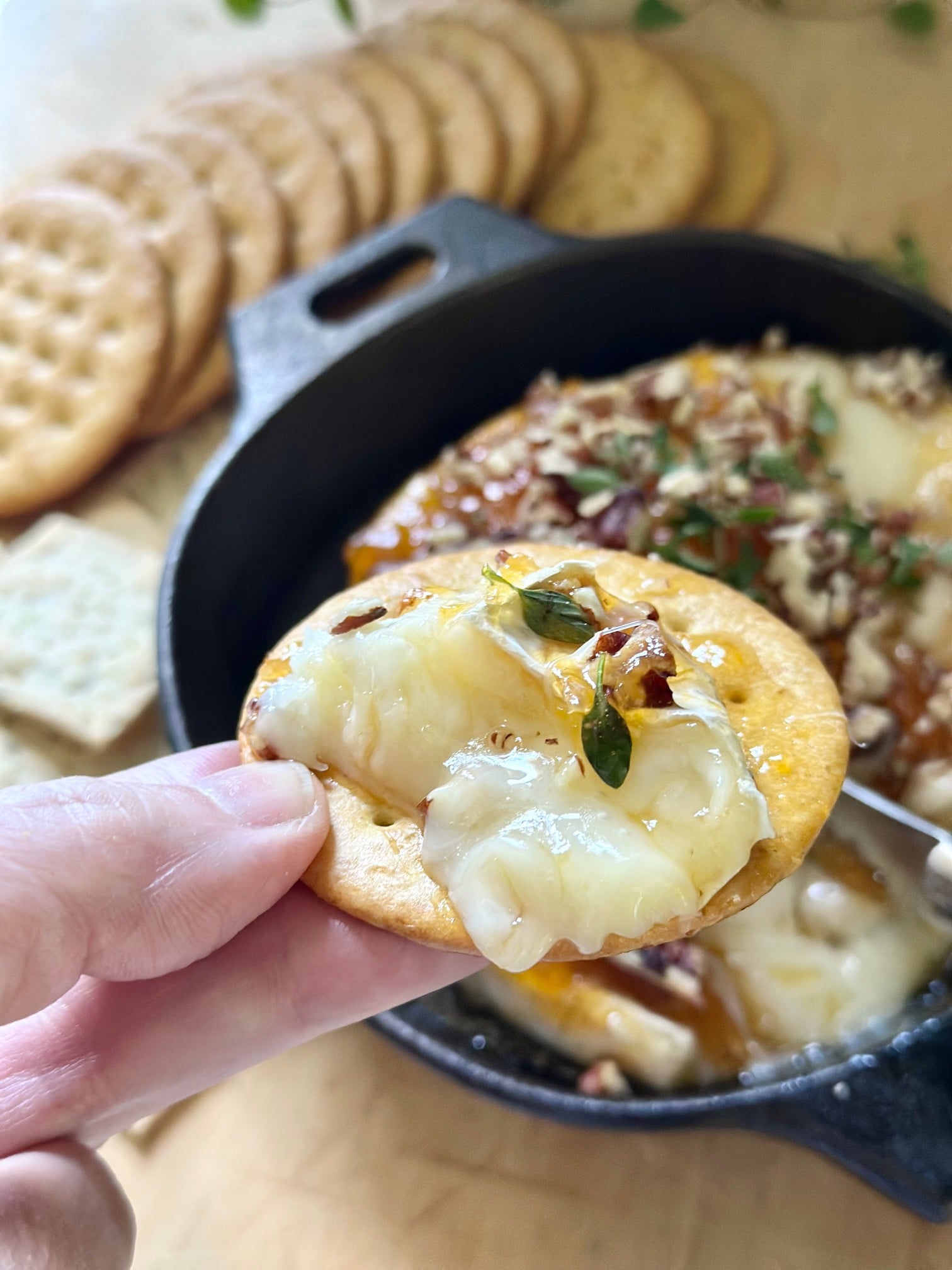 Scooped baked brie and crackers. 