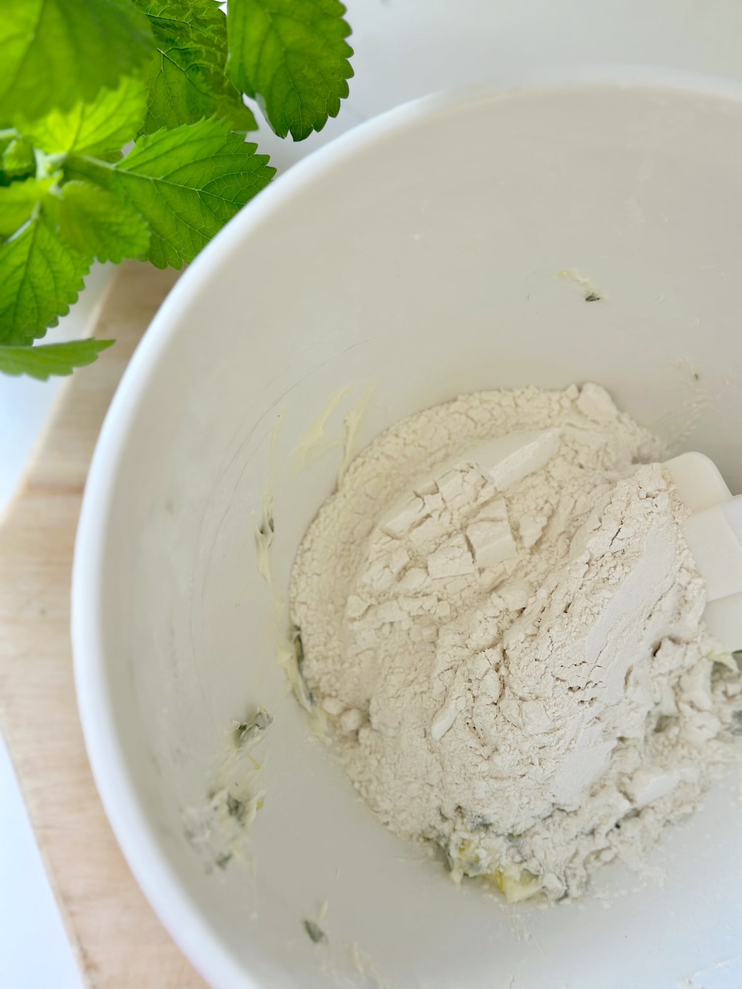 Adding flour to dough.