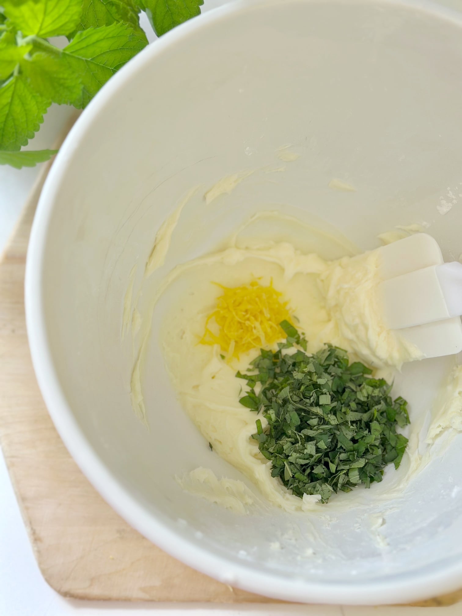 Adding lemon zest, chopped lemon balm and salt.