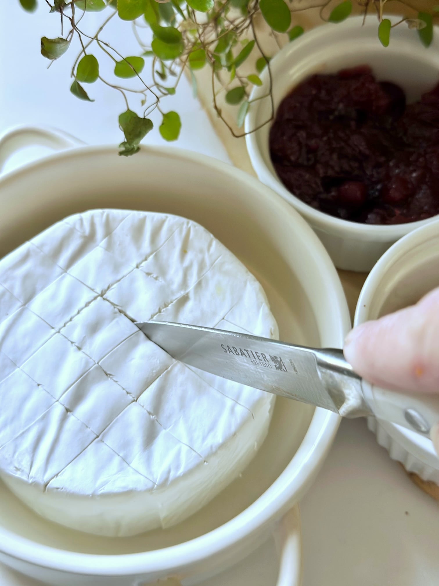 Score the top of a wheel and brie.