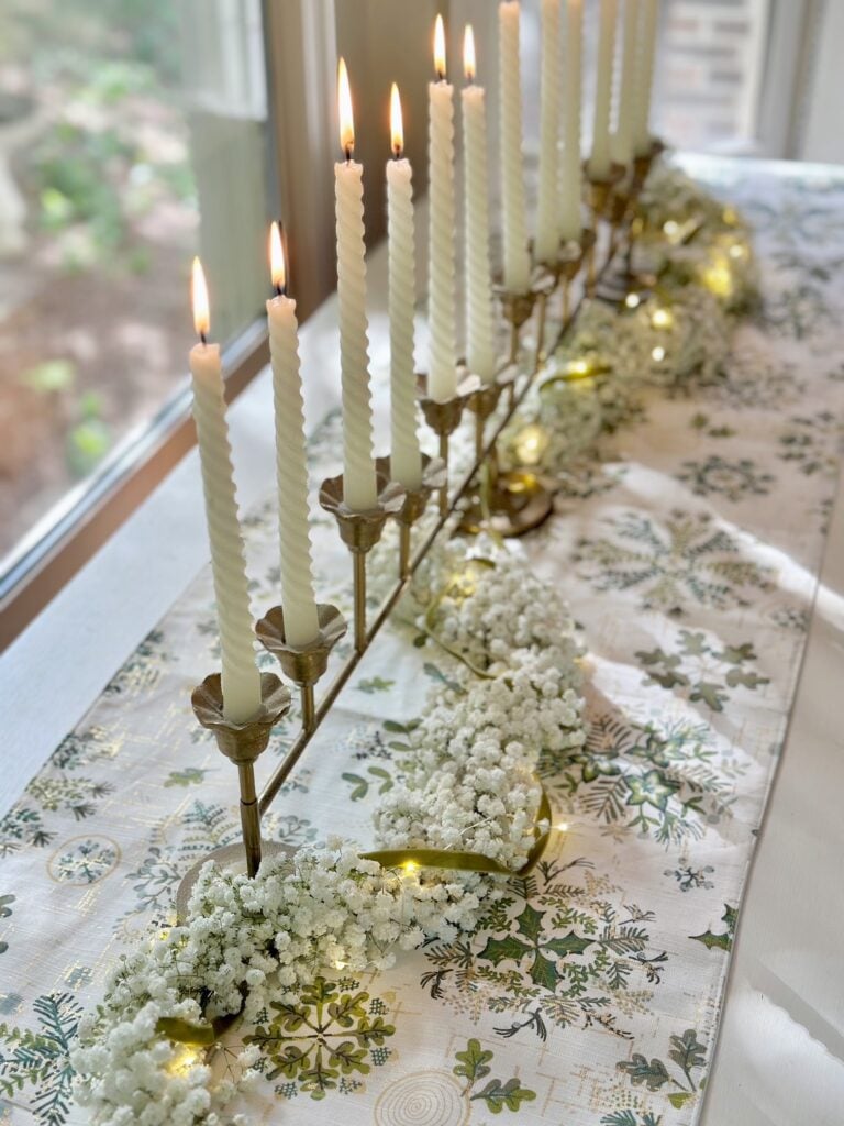 Baby's breath garland running through a candelabra for a beautiful Christmas table centerpiece. 
