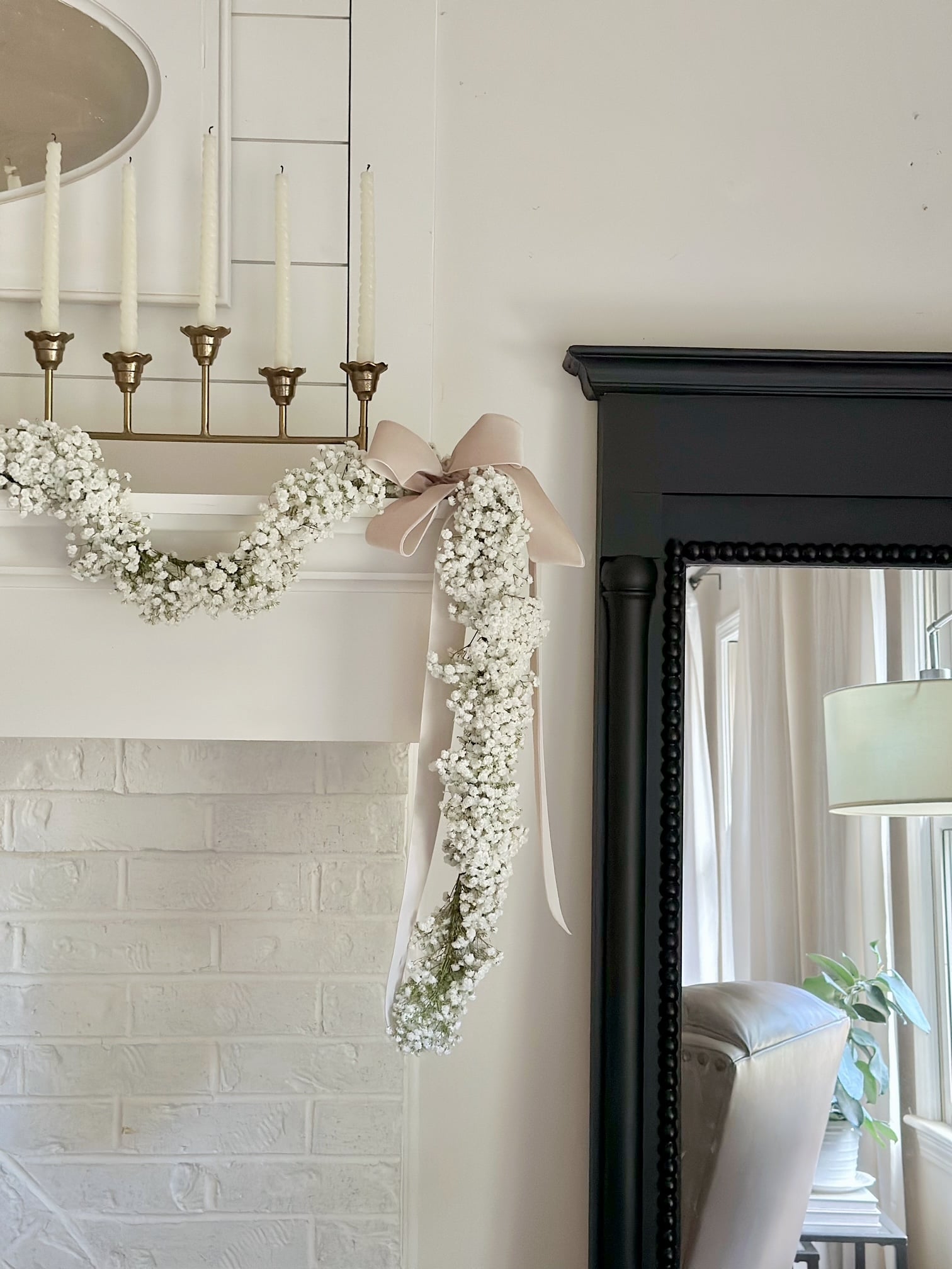 A front view of the full baby's breath garland hanging on the mantel. 