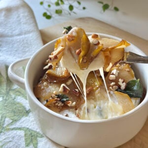 Baked brie with pears in a baking dish.