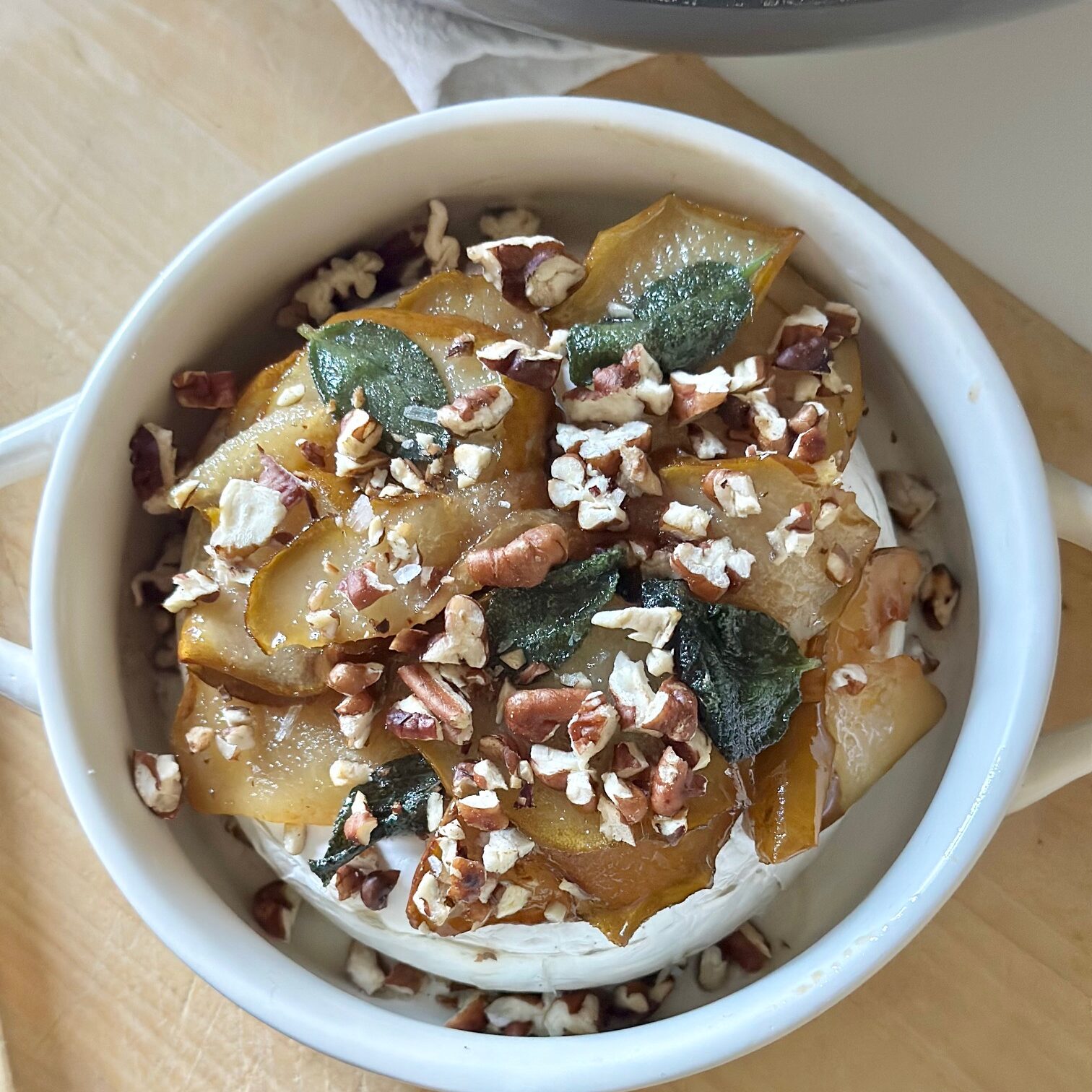 Baked brie all assembled with pears, and pecans.