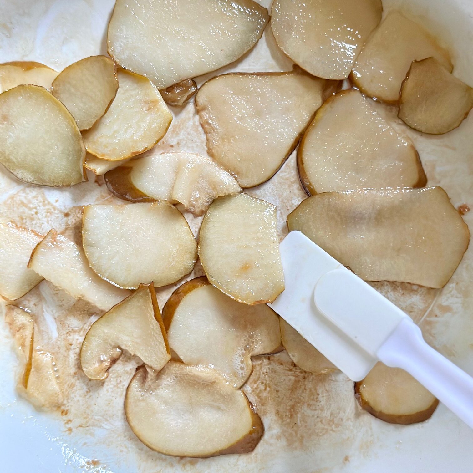 Caramelizing pears in a skillet with brown sugar.