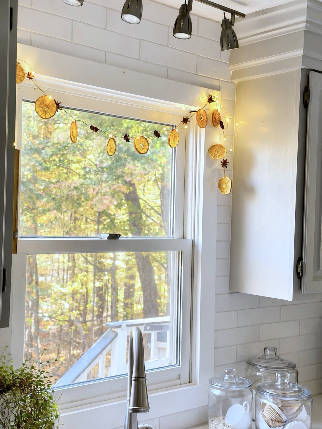Dehydrated orange slice garland in a kitchen window. 