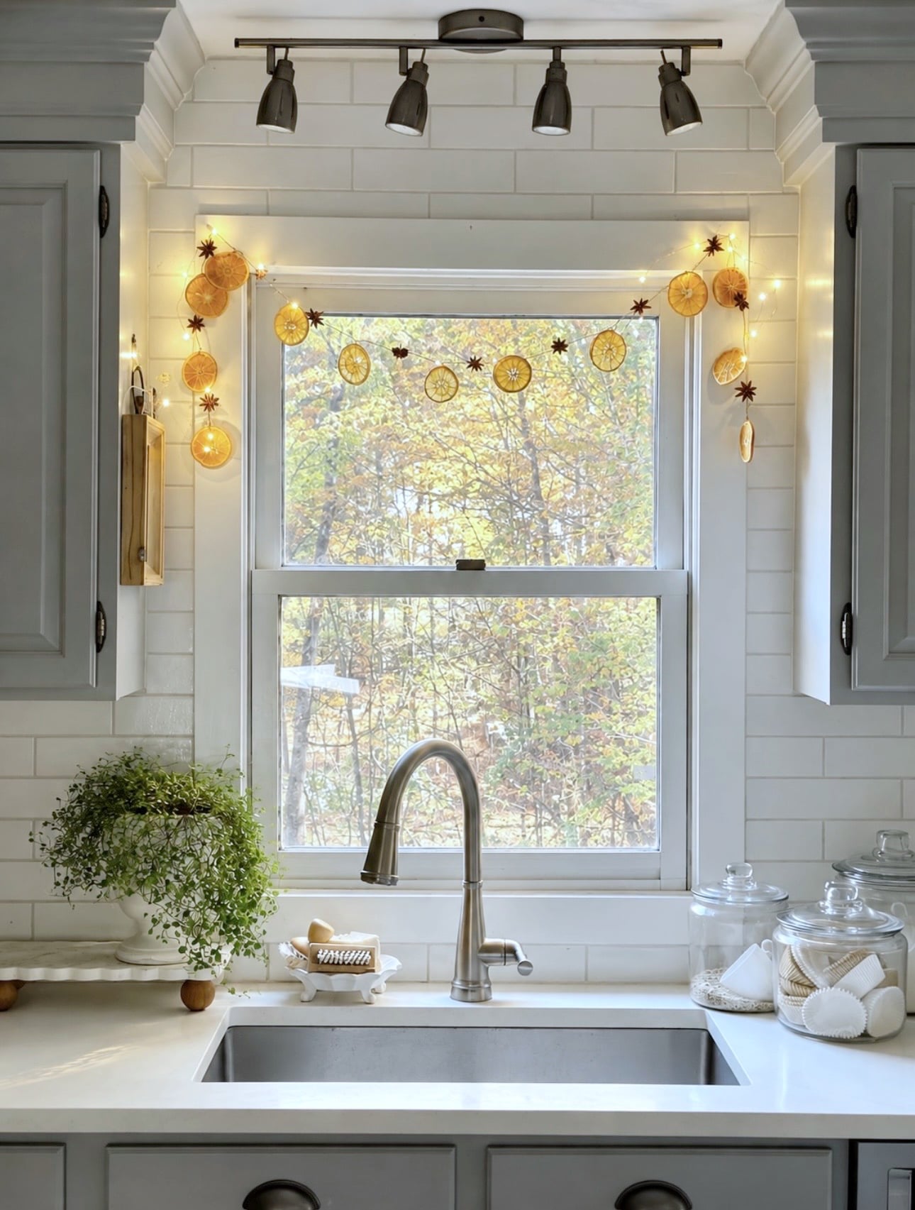 Orange garland with lights hanging in a window.