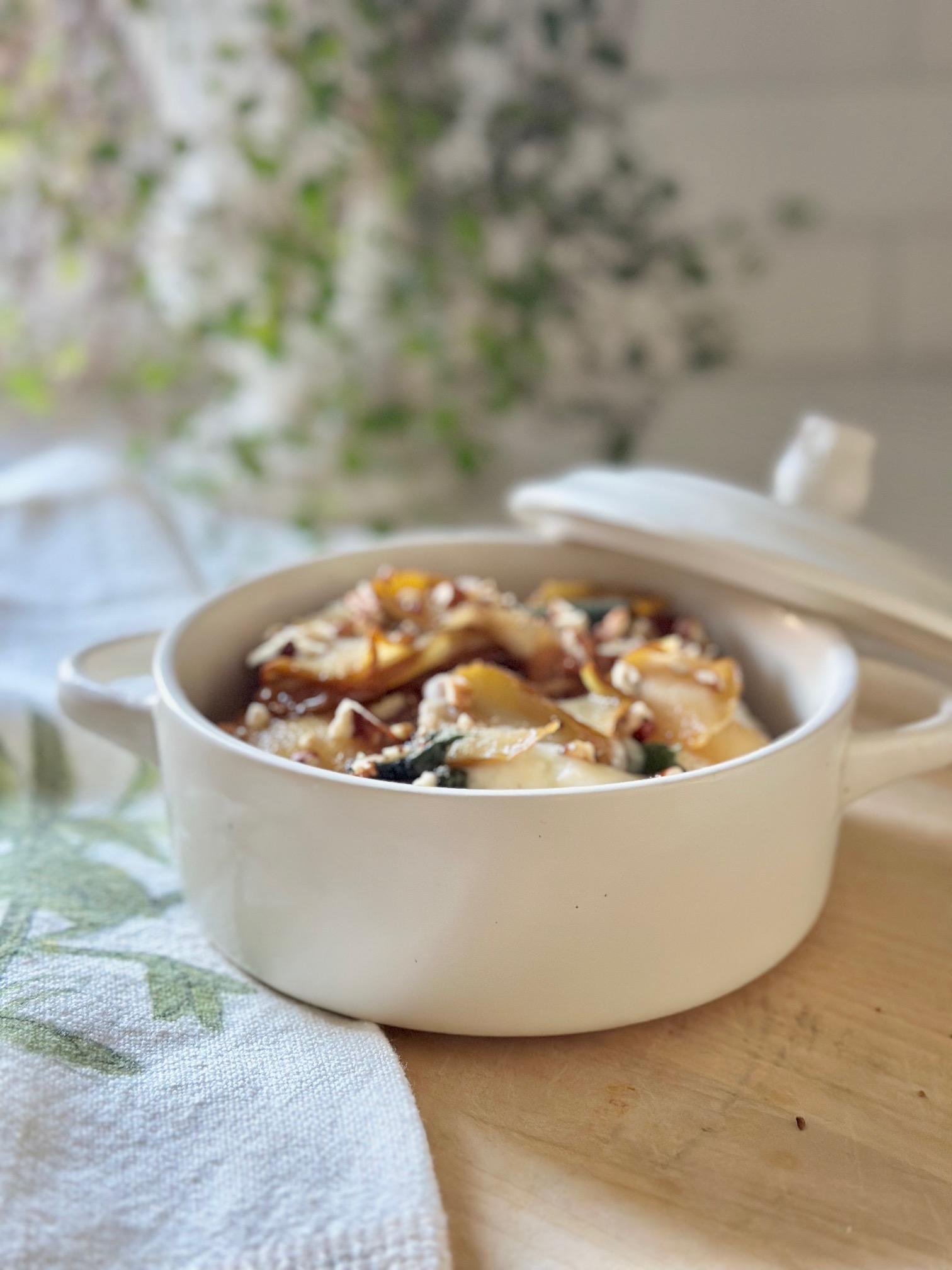 A beautiful baked brie topped with caramelized pears, honey, fresh sage from the garden and roasted pecans.