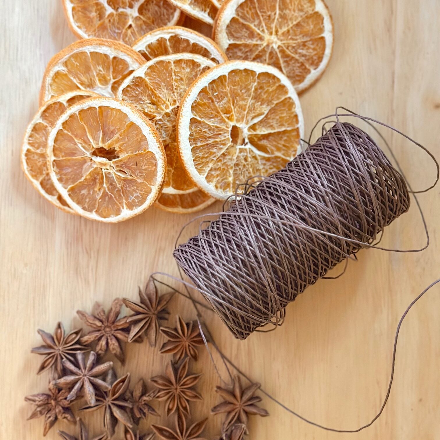 Supplies for a dried orange and star anise garland.