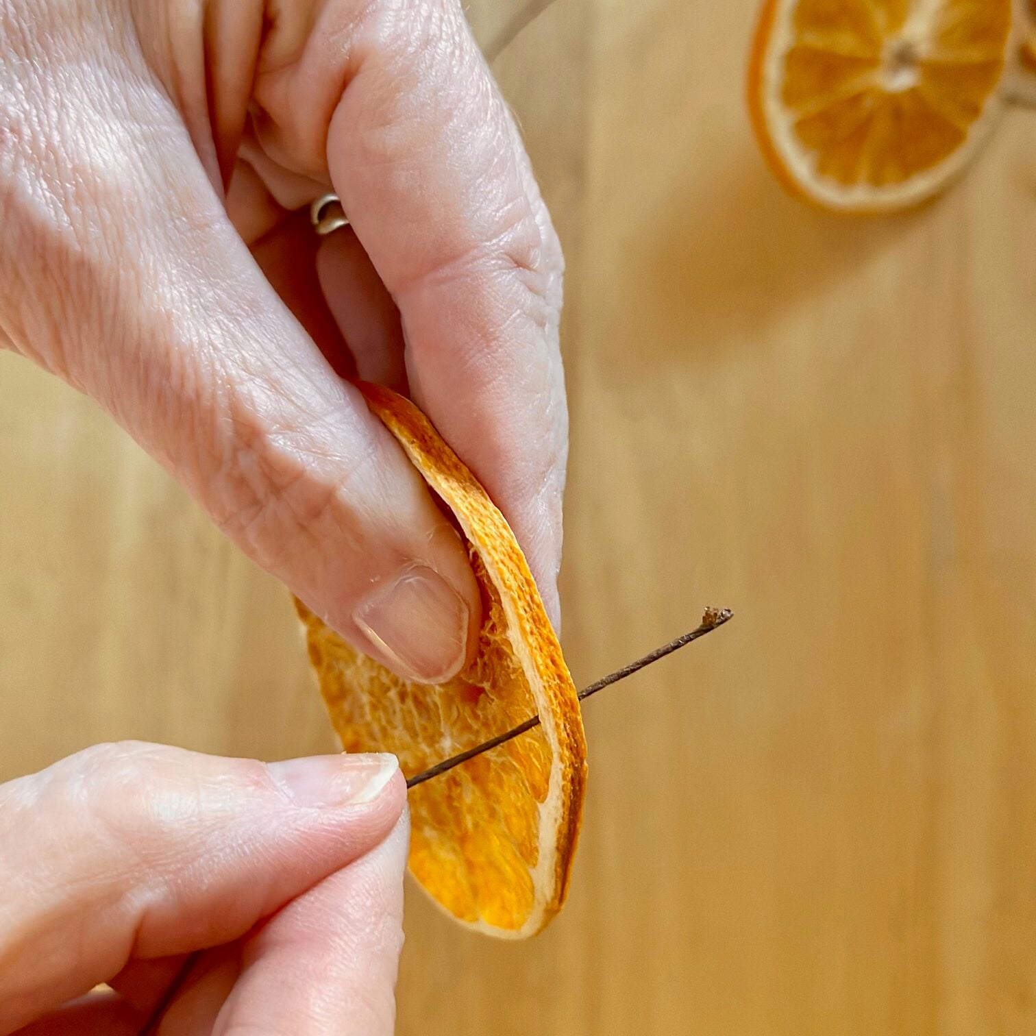 Wire pushed through a dried orange slice. 
